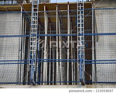 preparation of reinforced steel framework showing tie wires and alignment for loadbearing structures 133058697