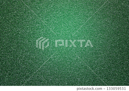 Green glitter textured paper showing gleaming particles, suitable for festive, celebration, or luxurious concepts 133059531