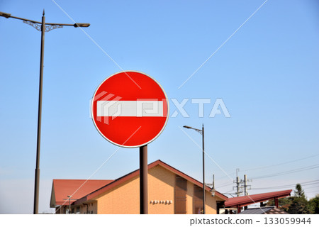Road sign, no vehicle entry, one-way exit and blue sky 133059944