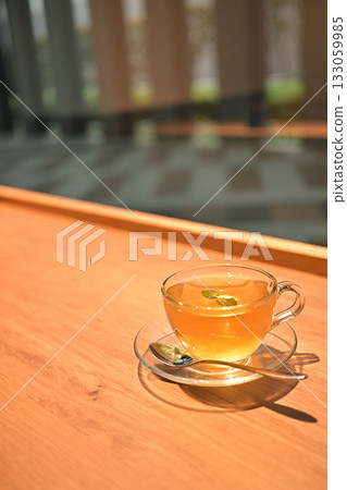 Relaxing tea time by the window with herbal tea in a glass cup Relaxing tea time by the window with herbal tea in a glass cup 133059985