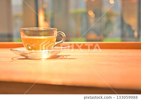 Relaxing tea time by the window with herbal tea in a glass cup Relaxing tea time by the window with herbal tea in a glass cup 133059988