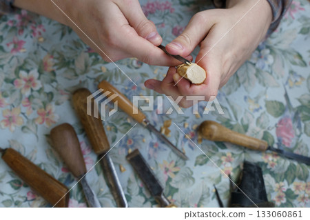 Man Carving Wood by Hand. Traditional Woodworking and Craftsmanship Tools Man Carving Wood by Hand. Traditional Woodworking and Craftsmanship Tools 133060861