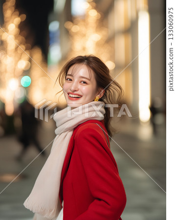 A woman meets up for a date in a town illuminated with Christmas lights during the Christmas season A woman meets up for a date in a town illuminated with Christmas lights during the Christmas season 133060975