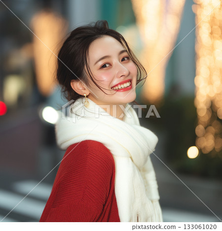A woman meets up for a date in a town illuminated with Christmas lights during the Christmas season 133061020