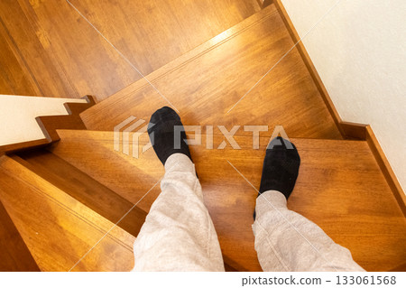 Person standing on wooden stairs Person standing on wooden stairs 133061568