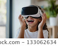 Portrait of happy smiling girl child person wearing virtual reality headset in room. 133062634