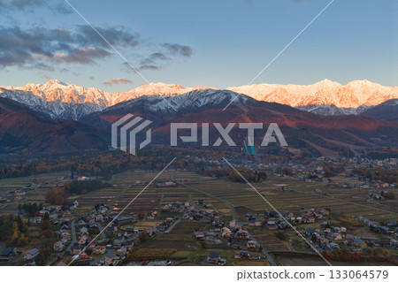 Happo-one Ski Resort in autumn colors and the snow-capped Hakuba mountain range in Hakuba Village, Nagano Prefecture (aerial shot taken by drone) Happo-one Ski Resort in autumn colors and the snow-capped Hakuba mountain range in Hakuba Village, Nagano Prefecture (aerial shot taken by drone) 133064579