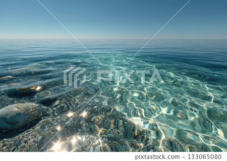 Ripples of clear, transparent ocean water with a horizon line. Pebbles on the bottom. 133065080