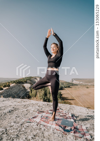 Yoga Practice on a Mountaintop with a Laptop Yoga Practice on a Mountaintop with a Laptop 133065229