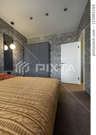 Cozy Bedroom with Patterned Wallpaper and Warm Blanket Cozy Bedroom with Patterned Wallpaper and Warm Blanket 133065268