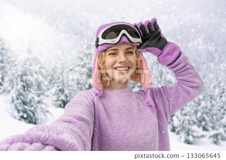 Woman in purple ski gear poses joyfully in snow Woman in purple ski gear poses joyfully in snow 133065645