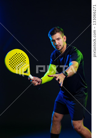 Player preparing for a shot in a dynamic padel match indoors 133066271