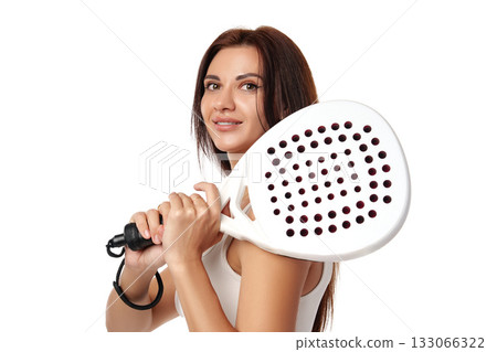 Young woman preparing for a game with a paddle in a bright setting 133066322
