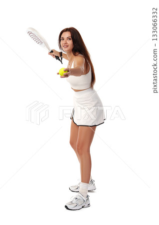 Woman preparing to hit a tennis ball during a game in a sports studio setting Woman preparing to hit a tennis ball during a game in a sports studio setting 133066332