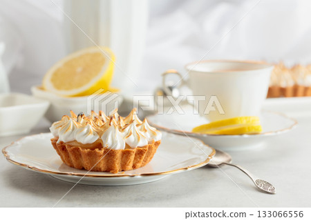 Meringue lemon tart on a white table. 133066556