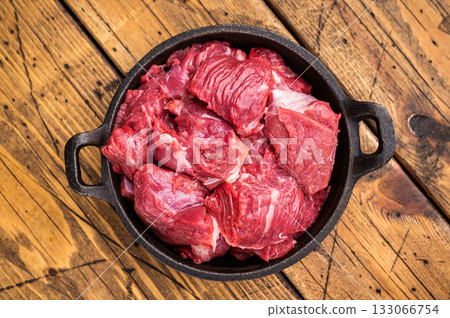 Freshly cut raw beef neck meat, waiting to be seasoned and cooked to perfection for your next culinary creation. wooden background. top view Freshly cut raw beef neck meat, waiting to be seasoned and cooked to perfection for your next culinary creation. wooden background. top view 133066754