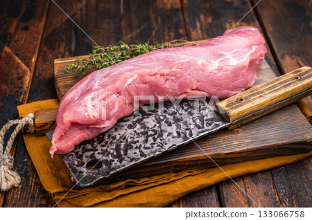 Juicy uncooked pork tenderloin, a versatile choice for any culinary creation you have in mind. wooden background. top view Juicy uncooked pork tenderloin, a versatile choice for any culinary creation you have in mind. wooden background. top view 133066758