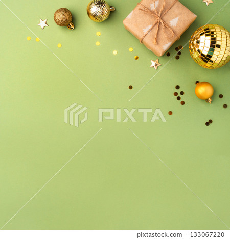 Christmas gift with ornaments on a green background 133067220