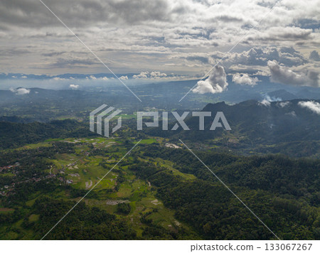Aerial view of mountains with green forests and agricultural land with farm plantations. Bukittinggi, Sumatra. Indonesia. 133067267