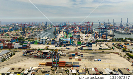 Port area with containers and cargo cranes view from above. Tanjung Priok sea port. Indonesia. Port area with containers and cargo cranes view from above. Tanjung Priok sea port. Indonesia. 133067287