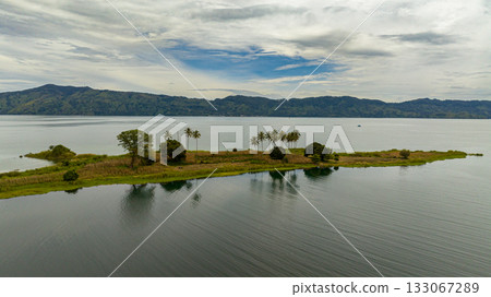 Aerial drone of beautiful Lake Toba and an island with palm trees. Samosir, Pulau Toba. Sumatra, Indonesia. 133067289