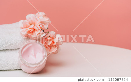 Pink cream jar and carnations with copy space 133067834