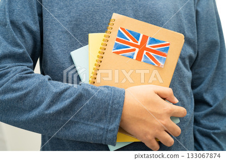 Learn English language, Asian teenage student hold book with flag in course at school. 133067874