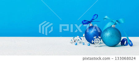 Christmas ball on colored background. decoration bauble with ribbon bow with copy space Christmas ball on colored background. decoration bauble with ribbon bow with copy space 133068024