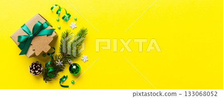 Top view Flat lay Christmas decorations and gift box on colored background with copy space. Christmas or Happy New Year composition Top view Flat lay Christmas decorations and gift box on colored background with copy space. Christmas or Happy New Year composition 133068052