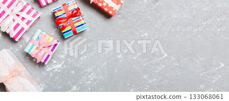Top view of Christmas background made of gift boxes on cement background. New year holiday concept with copy space Top view of Christmas background made of gift boxes on cement background. New year holiday concept with copy space 133068061