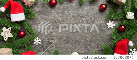 Christmas decorations and fir tree branch and gift boxon dark table. Top view frame with copy space Christmas decorations and fir tree branch and gift boxon dark table. Top view frame with copy space 133068075