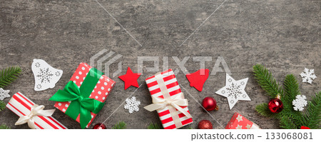 Christmas decorations and fir tree branch and gift boxon dark table. Top view frame with copy space Christmas decorations and fir tree branch and gift boxon dark table. Top view frame with copy space 133068081