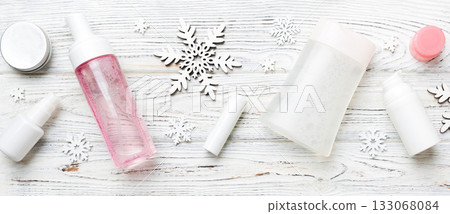 Makeup products and Christmas decorations on color background. Top view New year Beauty concept with copy space Makeup products and Christmas decorations on color background. Top view New year Beauty concept with copy space 133068084
