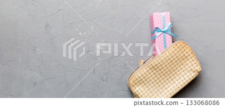 Christmas flat lay with makeup cosmetic products in cosmetic bag on colored background. Top view New year Beauty concept 133068086