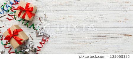 Holiday flat lay with gift boxes wrapped in colorful paper and tied decorated with confetti on colored background. Christmas, Birthday, Valentine and sale concept, top view Holiday flat lay with gift boxes wrapped in colorful paper and tied decorated with confetti on colored background. Christmas, Birthday, Valentine and sale concept, top view 133068325