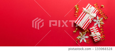 Holiday flat lay with gift boxes wrapped in colorful paper and tied decorated with confetti on colored background. Christmas, Birthday, Valentine and sale concept, top view 133068328