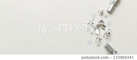 Christmas crackers with shiny confetti on color background, top view, copy space Christmas crackers with shiny confetti on color background, top view, copy space 133068341