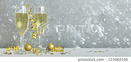 Champagne glasses and christmas decor on colored holiday background. Flat lay New Year decorations 133068396