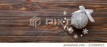 Christmas ball on colored background. decoration bauble with ribbon bow with copy space 133068423