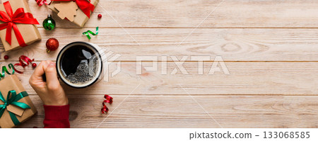 Woman holding cup of coffee. Woman hands holding a mug with hot coffee. Winter and Christmas time concept 133068585