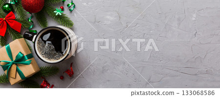 Delicious fresh festive morning coffee in a ceramic cup with little wrapped gifts, ornament and xmas toy. Cup of coffee and new year toys Delicious fresh festive morning coffee in a ceramic cup with little wrapped gifts, ornament and xmas toy. Cup of coffee and new year toys 133068586