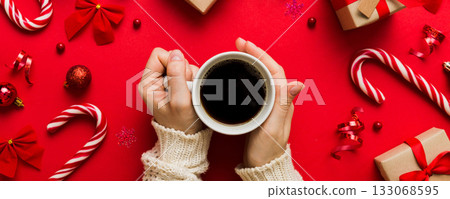 Woman holding cup of coffee. Woman hands holding a mug with hot coffee. Winter and Christmas time concept 133068595