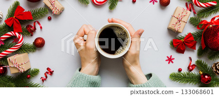 Woman holding cup of coffee. Woman hands holding a mug with hot coffee. Winter and Christmas time concept Woman holding cup of coffee. Woman hands holding a mug with hot coffee. Winter and Christmas time concept 133068601