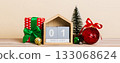 25 december. Christmas composition on colored background with a wooden calendar, with a gift box, toys, bauble copy space 133068624