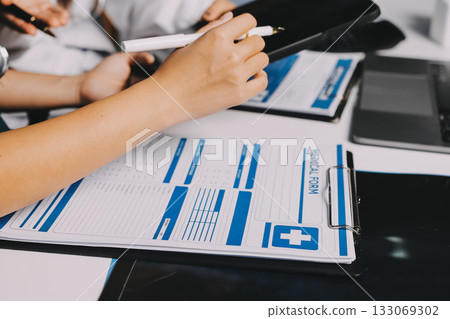 Group of doctors attending seminar in hospital lecture hall with senior physician giving medical presentation and professional training session on healthcare practices 133069302