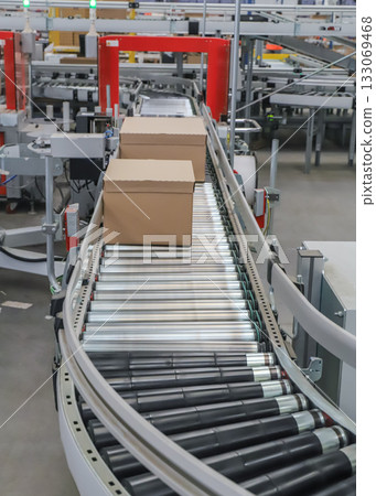 packing line in a logistics warehouse. conveyor belt in a modern production line packing line in a logistics warehouse. conveyor belt in a modern production line 133069468