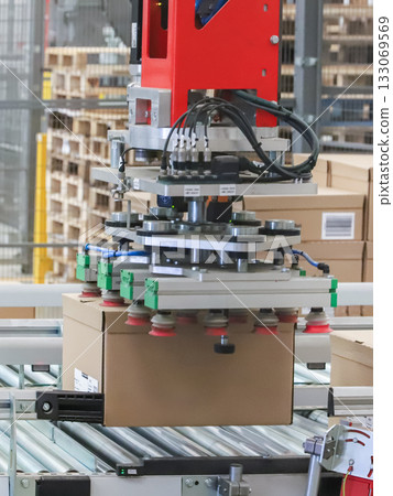 packing line in a logistics warehouse. conveyor belt in a modern production line packing line in a logistics warehouse. conveyor belt in a modern production line 133069569