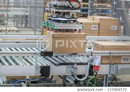 packing line in a logistics warehouse. conveyor belt in a modern production line packing line in a logistics warehouse. conveyor belt in a modern production line 133069572