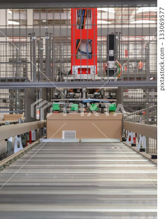 packing line in a logistics warehouse. conveyor belt in a modern production line packing line in a logistics warehouse. conveyor belt in a modern production line 133069577