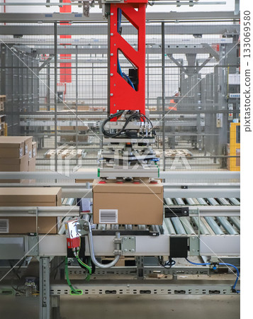 packing line in a logistics warehouse. conveyor belt in a modern production line 133069580
